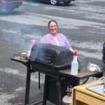 Woman Grilling Hamburgers
